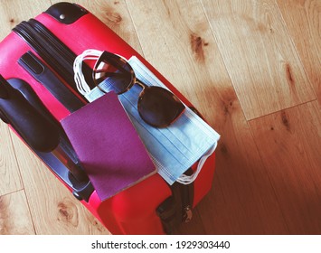 Top View Of A Pink Trolley With Sunglasses Mask And Passport, Concept Of Responsible Travel