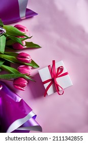 Top view pink tulips flowers in violet paper wrapper with gift box, festive background, concept of Happy Mother's day, Woman's day, birthday, 8 March, Valentines day - Shutterstock ID 2111342855