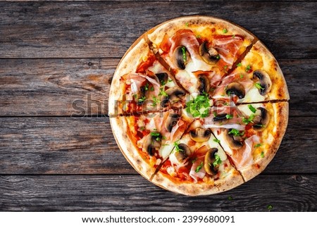 Top view of pizza speck with ham, mozzarella cheese and white mushrooms on wooden table 