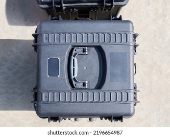 Top View Plastic Case. Plastic Impact-resistant Suitcase For Transporting Equipment. Case For Quadcopter Or Other Equipment. Plastic Box Lid Top View. Transport Box On Ground Close-up