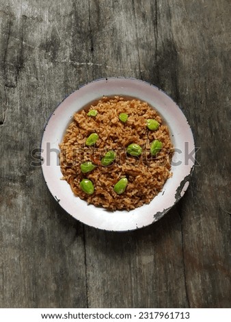 Top view A plate of Bitter Bean Fried Rice or Nasi Goreng Pete, Indonesia's favorite dish of fried rice with spices and added with Petay or Pete . Selective focus, isolated, bright, wooden background. Imagine de stoc © 