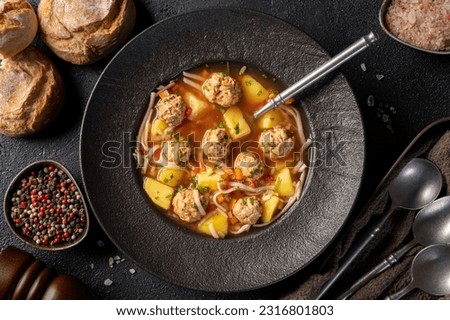 Top view of plate with meatballs soup, romanian traditional cuisine - Ciorba de perisoare