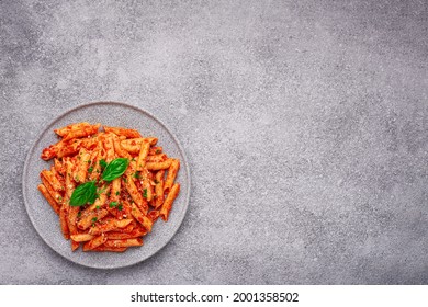 Top view plate Penne All'arrabbiata pasta cooked according to a traditional Italian recipe with copy space - Shutterstock ID 2001358502