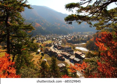 The Top View Point Of Shirakawago Village In Autumn, Japan. Gassho House Is World Heritage Site Of UNESCO. Create A Frame For Photos With Brightly Colored Trees.