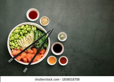 Top view of poke bowls composition with various sauces