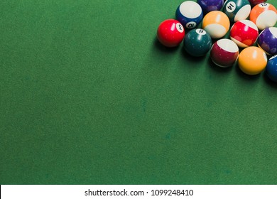 Top view of pool billiards snooker balls on green table with setup position ready for break.