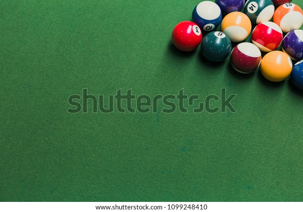 Top view of pool billiards\
snooker balls on green table with setup position ready for\
break.