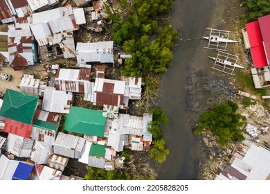 Top View Of A Poor Shanty Town By A Small River. At An Impoverished Coastal Area In The Town Of Ubay, Bohol. Example Of Urban Blight.