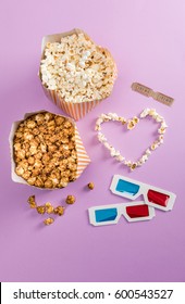 Top View Of Popcorn With Heart Symbol And 3D Glasses With Cinema Tickets Isolated On Purple, Movie Time Concept  