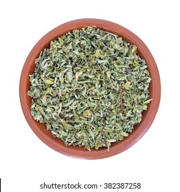 Top view of a portion of damiana leaf in a small bowl isolated on a white background.
