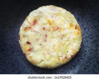Top view of potato cake. Food in a nonstick pan (circle shaped meal)