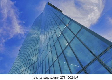 Top view of the Prime Tower, surrounded by clouds in the bright blue sky, Prime Tower, Zurich, glass facade, reflections, Canton of Zurich, Switzerland
