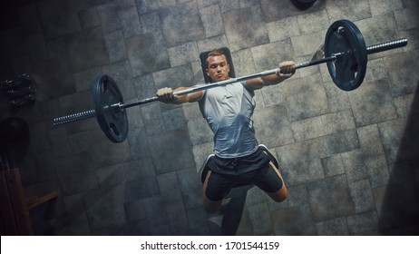 Top View Of Professional Athlete Doing Bench Press Workout With A Barbell In The Hardcore Gym. Muscular And Athletic Bodybuilder Doing Barbell Exercise.