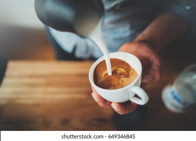 Top View Of Professional Barista Pouring Milk And Preparing Fresh Cappuccino, Hot Drinks And Coffee Preparations Concept, Lifestyle