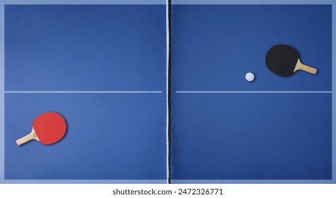 Top view of professional blue ping pong playing surface with paddles on each side and ball. Top view.