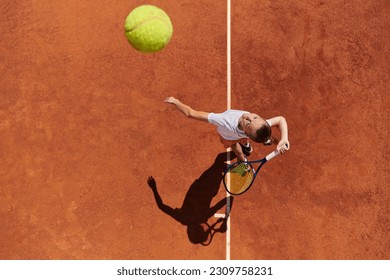 Top view of a professional female tennis player serves the tennis ball on the court with precision and power - Powered by Shutterstock