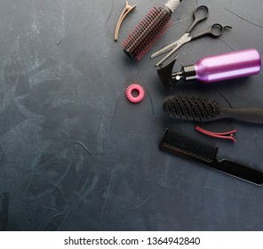 Top View Of Professional Hair Dresser Tools On Black Concrete Background