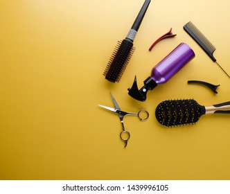 Top View Of Professional Hair Dresser Tools On Yellow Background