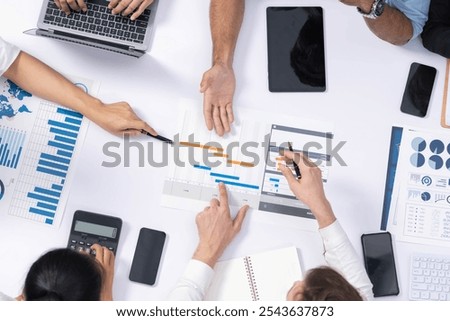 Top view project manager communicate and collaborate with team using project management software, tracking progress of project task and making schedule plan at meeting table. Prudent