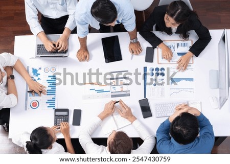 Top view project manager communicate and collaborate with team using project management software, tracking progress of project task and making schedule plan at meeting table. Prudent