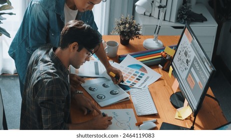 Top view of project manager looking at screen while designer writing idea. Close up of smart business team explain idea of logo design while designer choose theme while looking at palette. Symposium. - Powered by Shutterstock