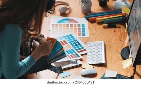 Top view of project manager looking at screen while designer writing idea. Close up of smart business team explain idea of logo design while designer choose theme while looking at palette. Symposium. - Powered by Shutterstock