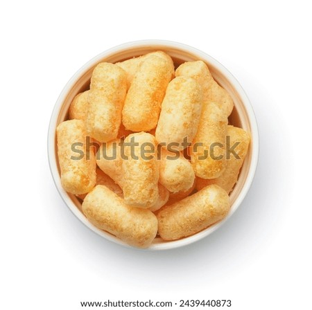 Top view of puffed corn snack in ceramic bowl isolated on white