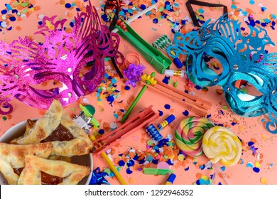 Top View Of Purim Background With Carnival Mask, Party Costume And Hamantaschen Cookies. Purim Celebration Concept