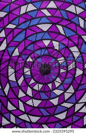 top view of purple and white ankara fabric, flatlay of nigerian wax cloth, rumpled purple and white ankara material