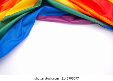 Top view of the rainbow flag or LGBT over a white background with copy space for text. Flat lay - Powered by Shutterstock