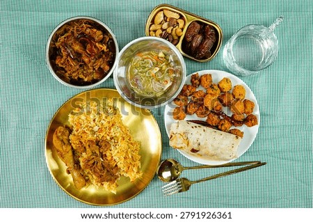 Top view Ramadan iftar table featuring chicken biryani, stuffed wraps, crispy fried snacks, dates and traditional halal dishes. Festive Middle Eastern dining and hospitality concept.