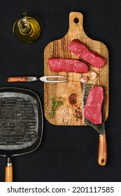 Top View Of Raw Boneless Beef Strip Steak On Black Background