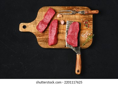 Top View Of Raw Boneless Strip Steak On Black Background