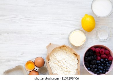 Top View, Raw Ingredients For Cooking Berry Pie On A White Wooden Surface. Flat Lay, Overhead. Copy Space.