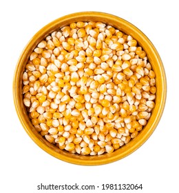 top view of raw maize (corn) seeds in round bowl cutout on white background