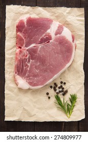 Top View Raw Pork Chop Steak On Wooden Background.