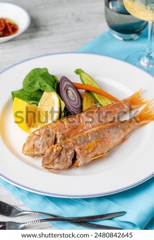 Top view of raw red mullet fish on ice on display at seafood fish market