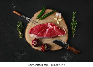 Top View Of Raw Top Sirloin Beef Steak On Wooden Cutting Board