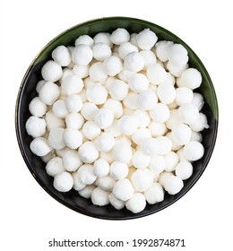 top view of raw tapioca pearls in round bowl isolated on white background