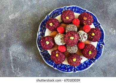 Top View Of Raw Vegan Sweet Candy Gluten-free Rolls With Carob, Hibiscus, Chia Seeds And Nuts