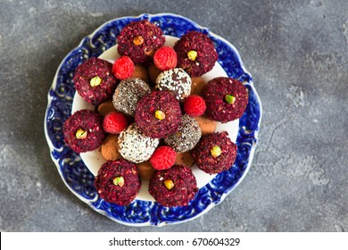 Top View Of Raw Vegan Sweet Candy Gluten-free Rolls With Carob, Hibiscus, Chia Seeds And Nuts