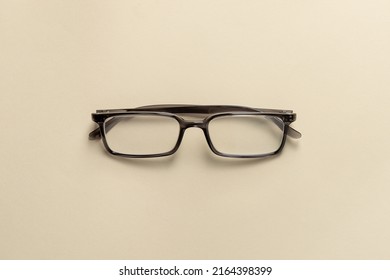 Top View Of Reading Glasses On A Cream Table