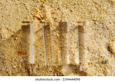 Top View Of Rectangular Acrylic Prisms On Sandy Beach Background, Refraction Light Creates Interesting Images Of Sand Grain. Distorted Images With Shade And Shadow. Size Of Image Is Increased. 