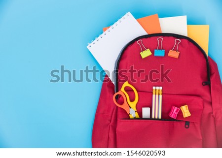 Top view Red bag backpack for education children on blue background back to school concept