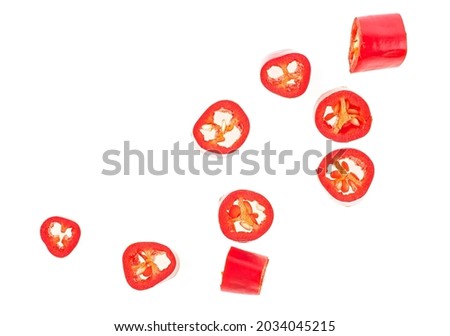Top view of red chopped chili peppers isolated on a white background. Pieces of red hot chili pepper.