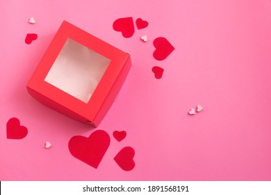 Top View Of Red Empty Gift Box On Pink Color Table. Valentines Day Packing. Decor Hearts.