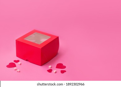 Top View Of Red Empty Gift Box On Pink Color Table. Valentines Day Packing. Decor With Hearts.