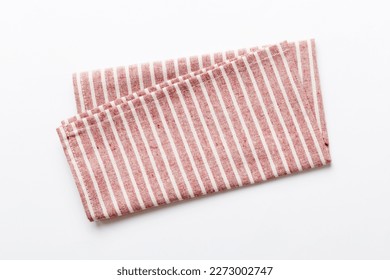 top view with red empty kitchen napkin isolated on table background. Folded cloth for mockup with copy space, Flat lay. Minimal style.