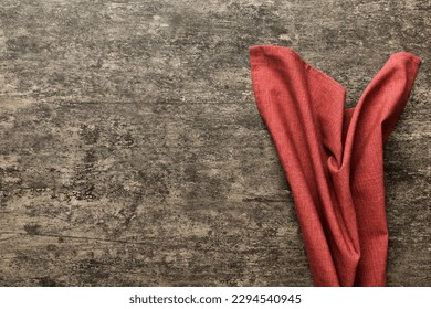 top view with red empty kitchen napkin isolated on table background. Folded cloth for mockup with copy space, Flat lay. Minimal style.
