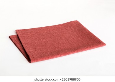 top view with red empty kitchen napkin isolated on table background. Folded cloth for mockup with copy space, Flat lay. Minimal style.